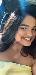 Angel Smiling woman in sunlight inside a car